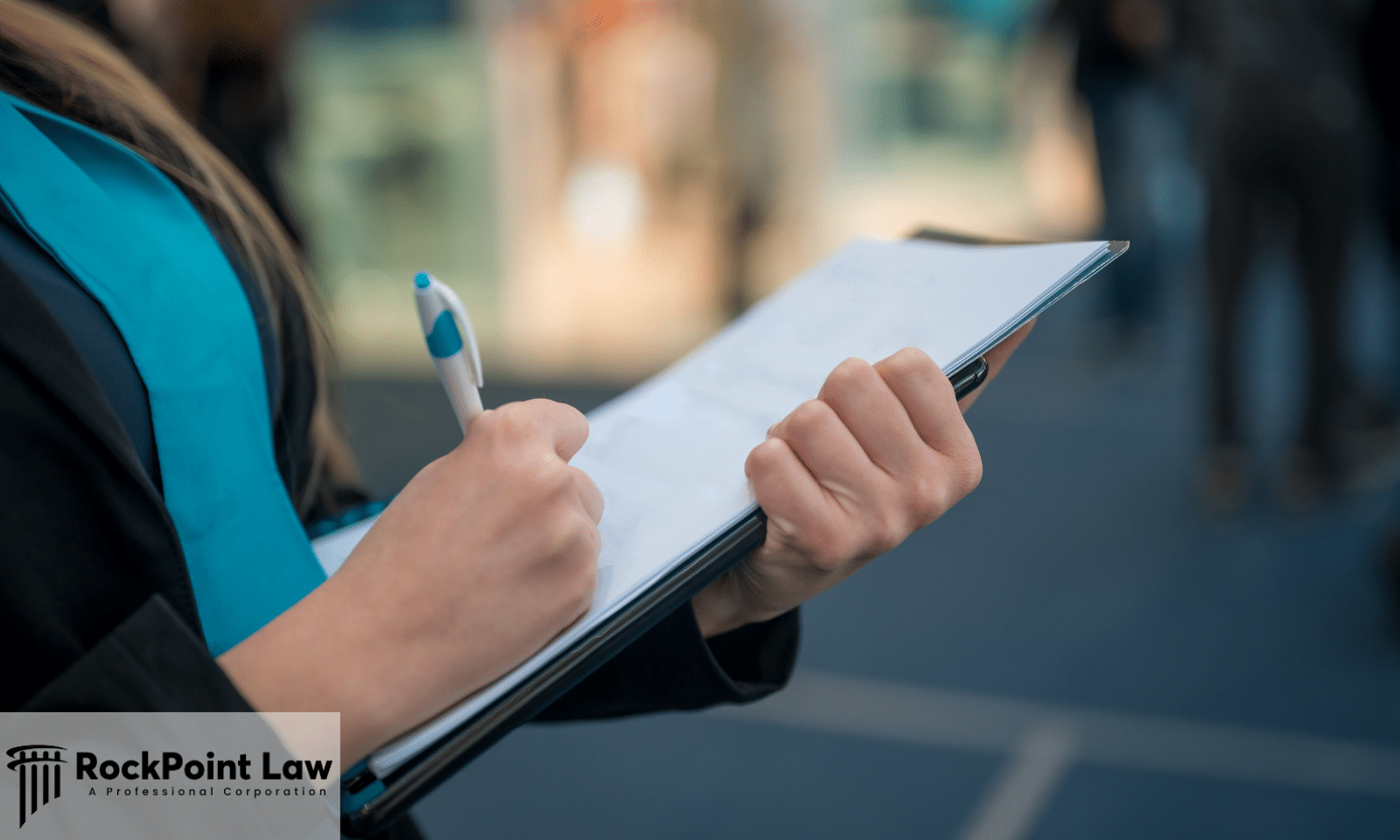 Person writing notes on a clipboard while documenting information for a Lemon Law claim