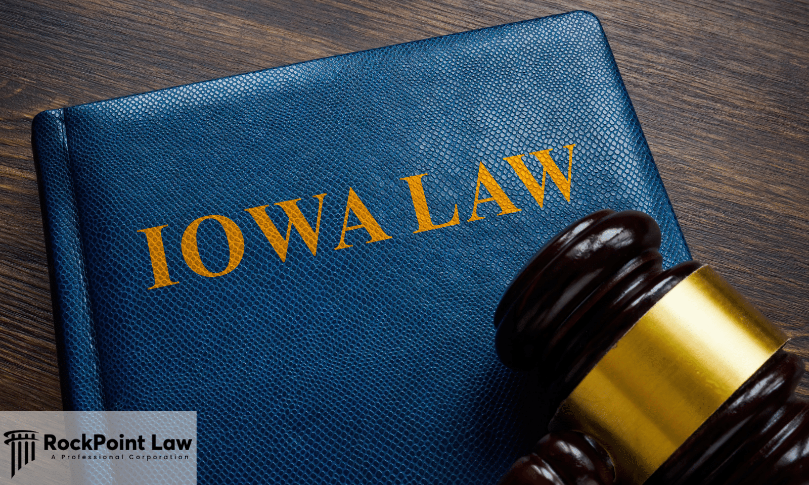 Judge's gavel resting on a law book labeled "Iowa Law" on a wooden desk, representing Iowa Lemon Law.
