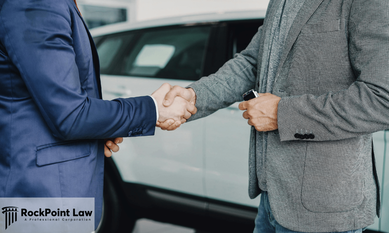 Customer and dealership representative shaking hands after completing a vehicle sale