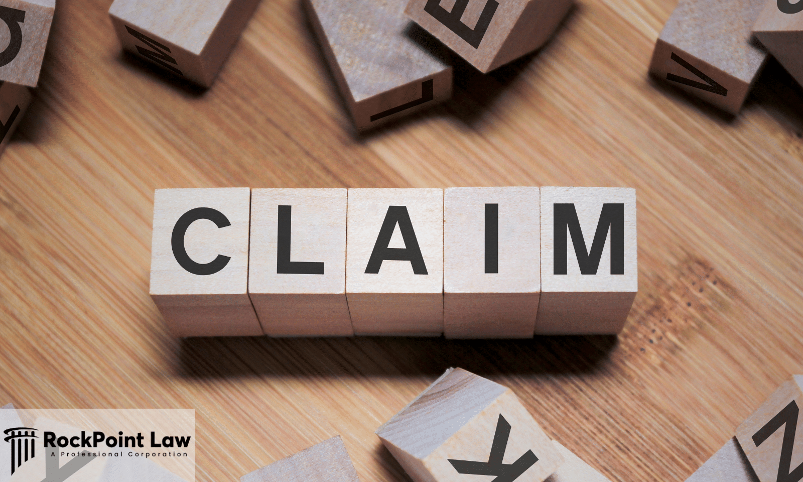 Wooden letter blocks spelling "CLAIM" on a wooden surface, representing the process of filing a lemon law claim.