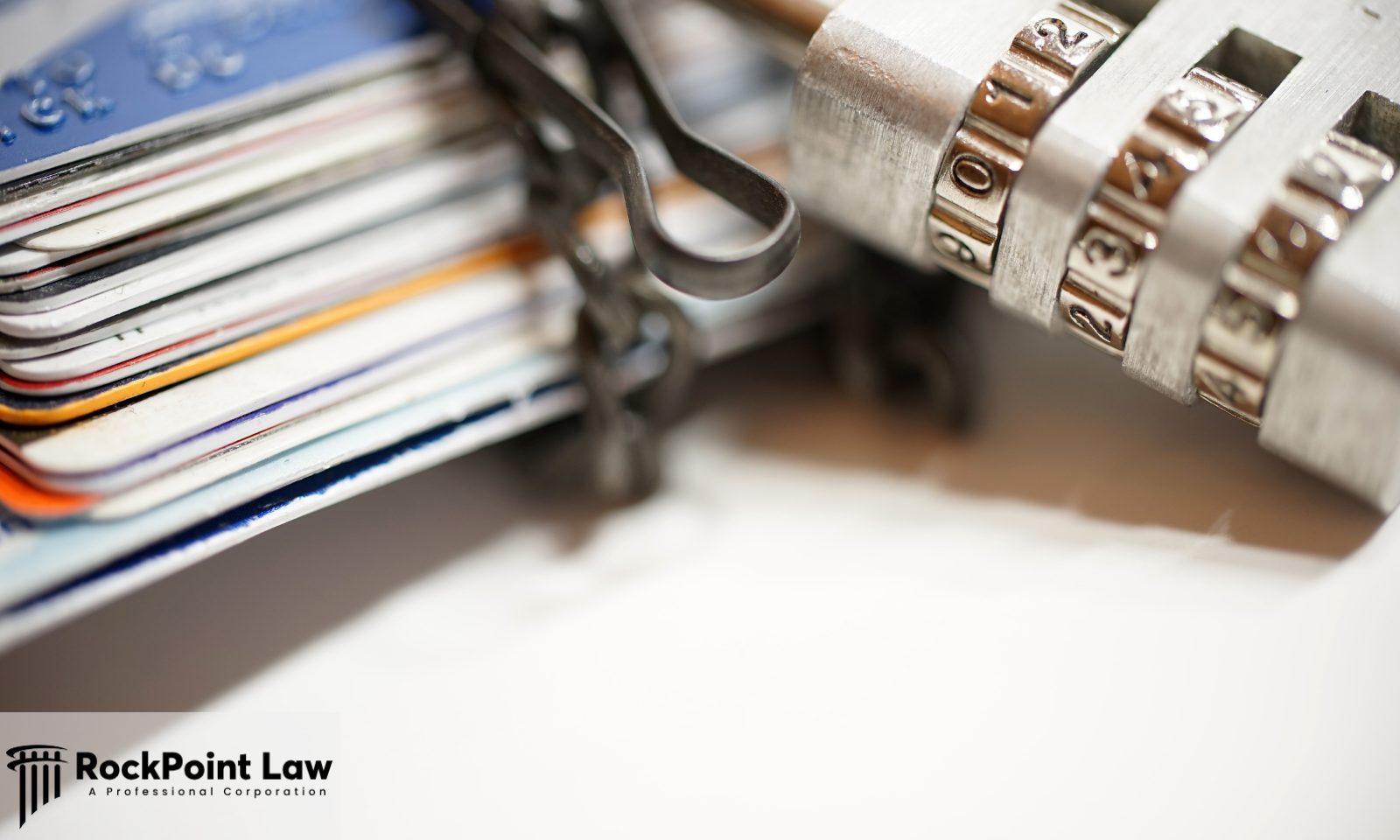 Close-up of stacked credit cards secured with a combination padlock to symbolize financial and personal data security