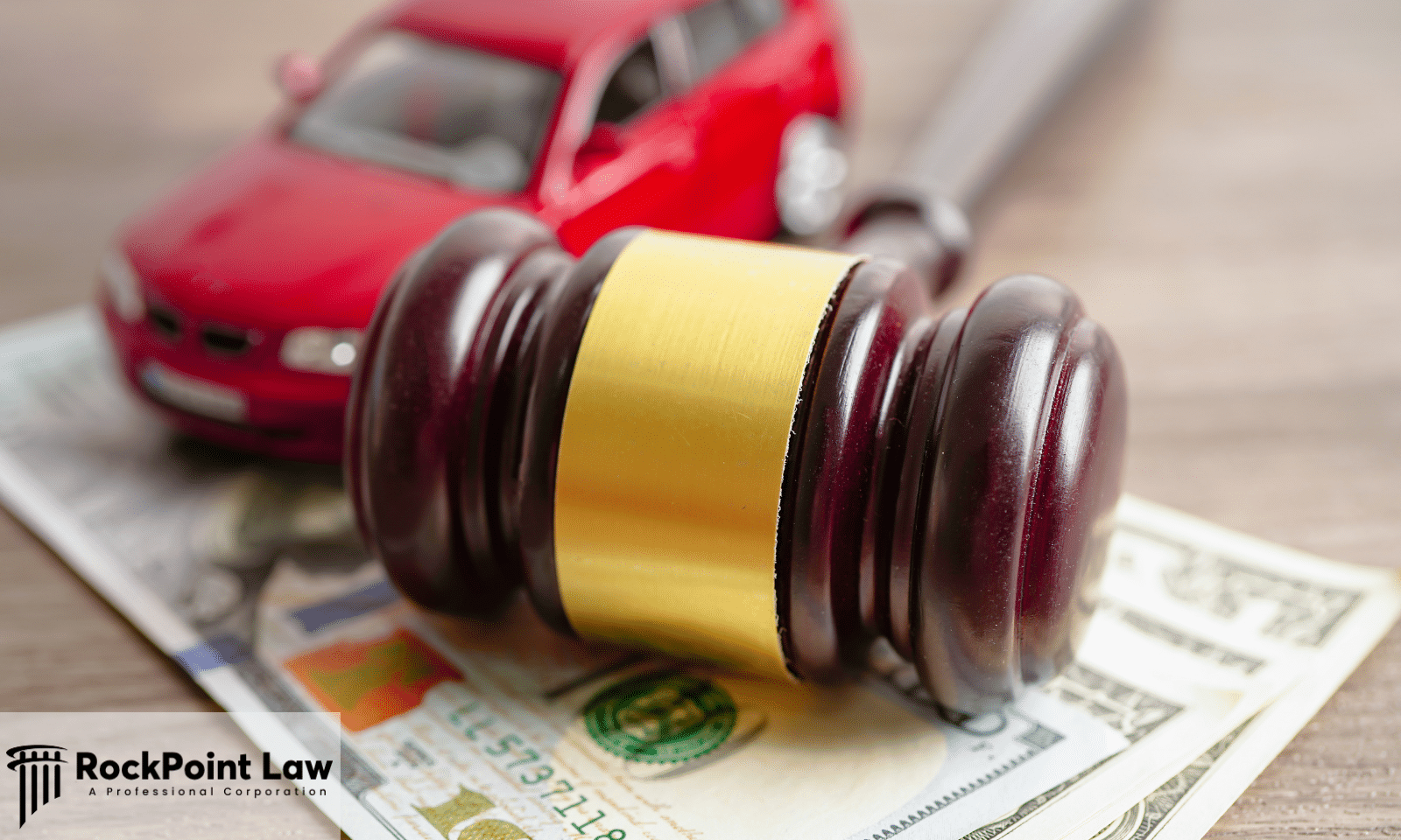 Judge's gavel resting on U.S. currency with a red vehicle in the background, symbolizing Lemon Law compensation.