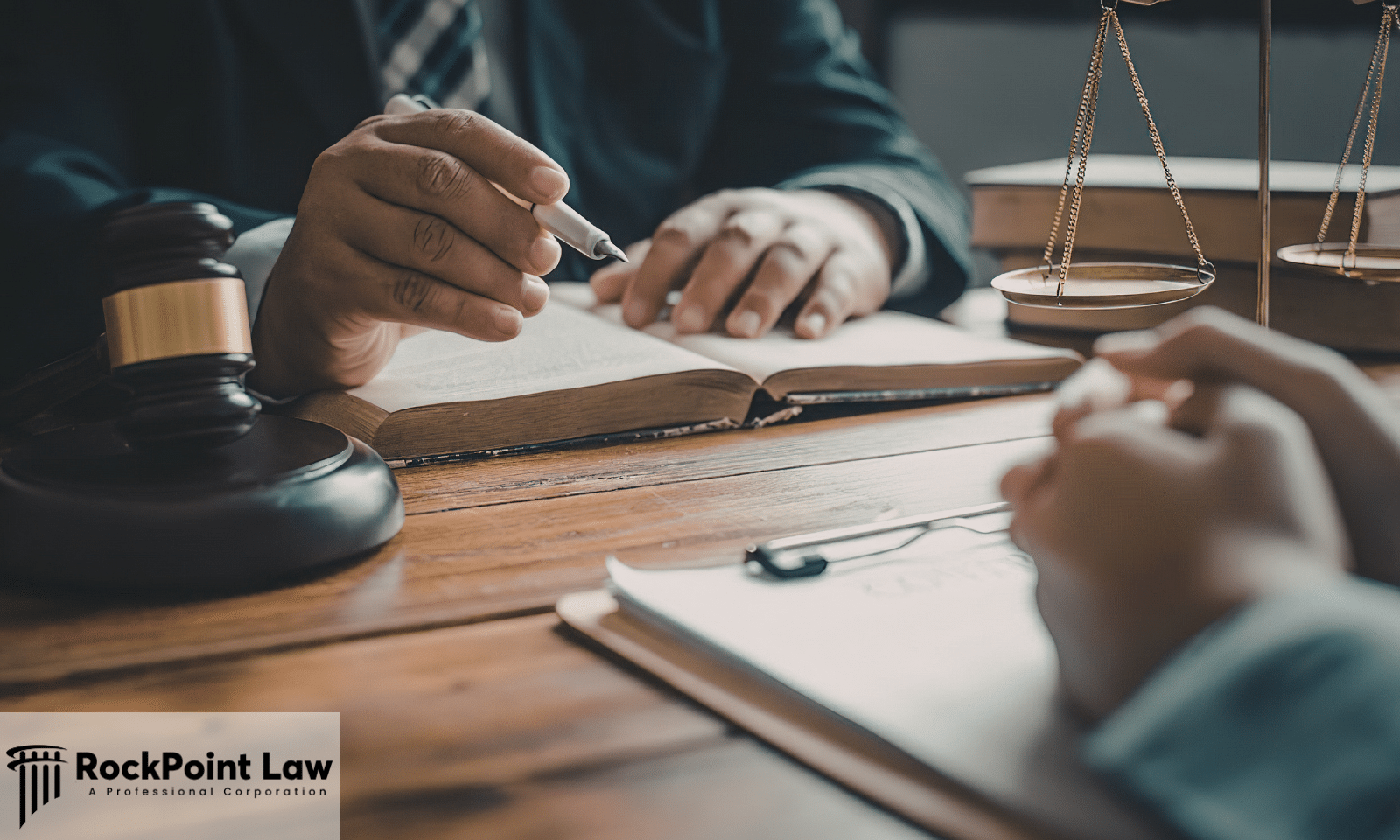 Attorney explaining Lemon Law rights to a client during a legal consultation with a gavel, law book, and documents.
