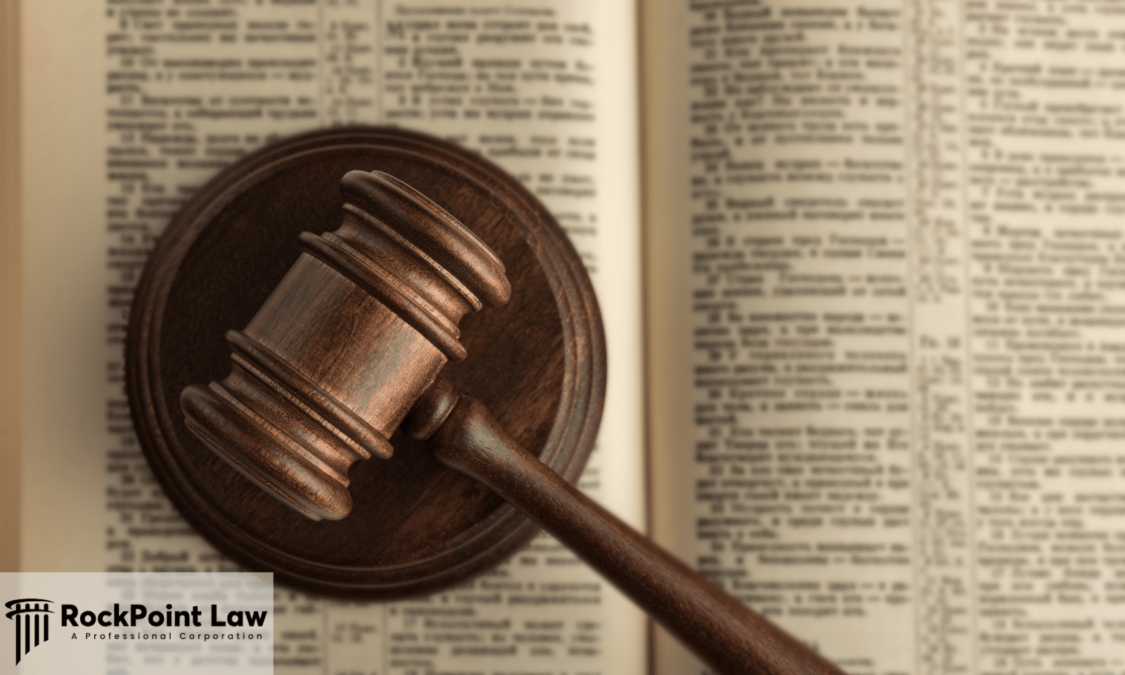 Wooden judge's gavel resting on an open law book, symbolizing Lemon Law statutes, consumer protection, and legal rights.