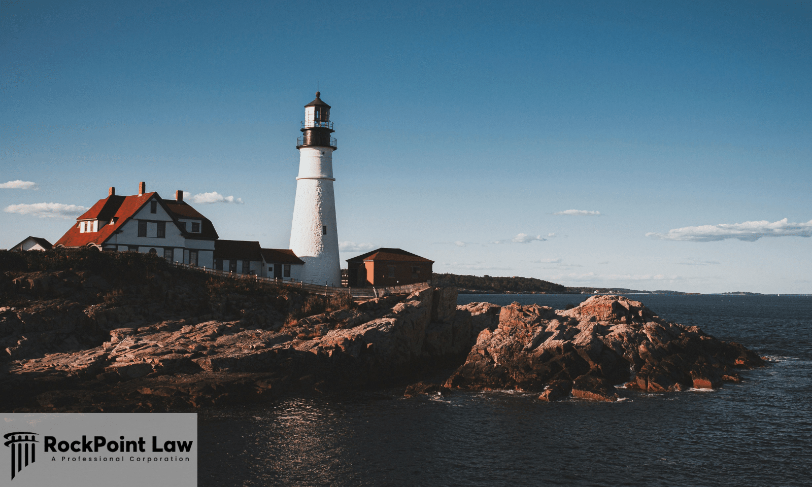 Historic lighthouse on the rocky coast of Maine overlooking the Atlantic Ocean.