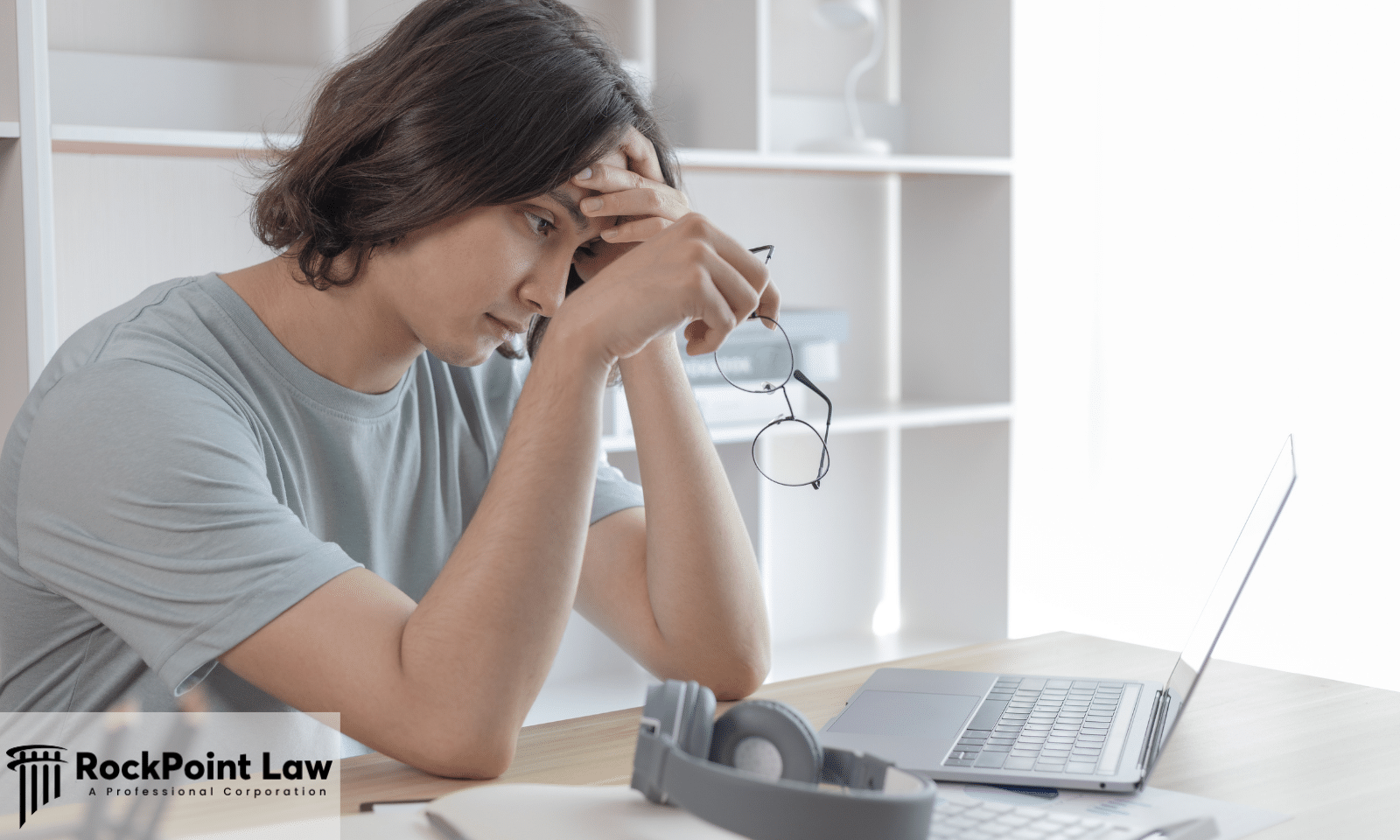 A frustrated vehicle owner resting his head on his hand at a laptop, representing common mistakes that weaken a lemon law claim.