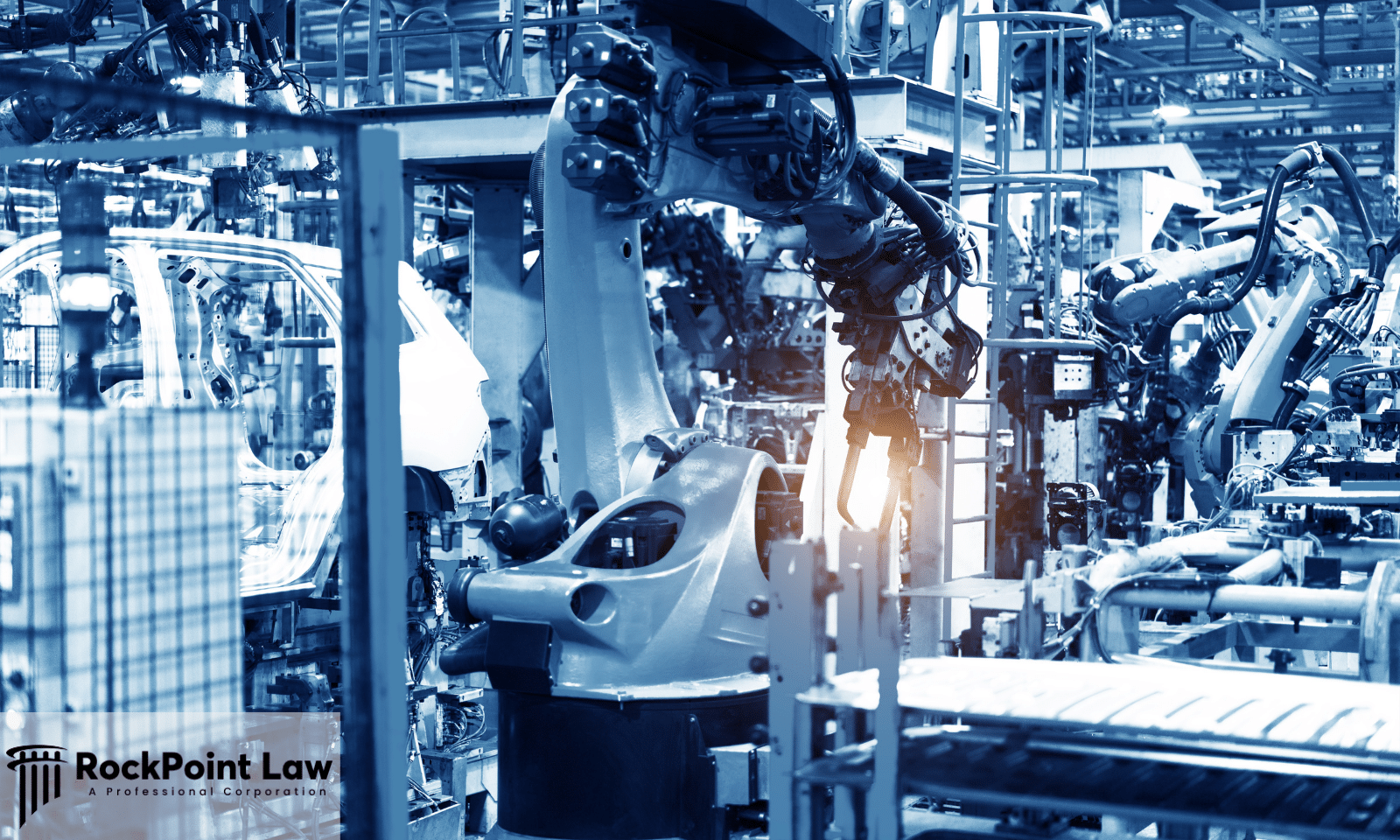 Robotic arms assembling car bodies on an automotive production line, representing the manufacturer's role in a lemon law claim.