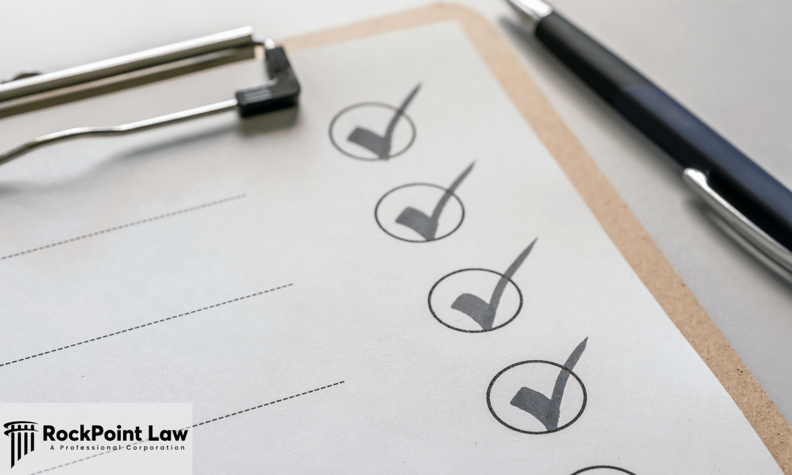 A checklist on a clipboard with ticked boxes and a pen, representing the documents needed for a lemon law claim.
