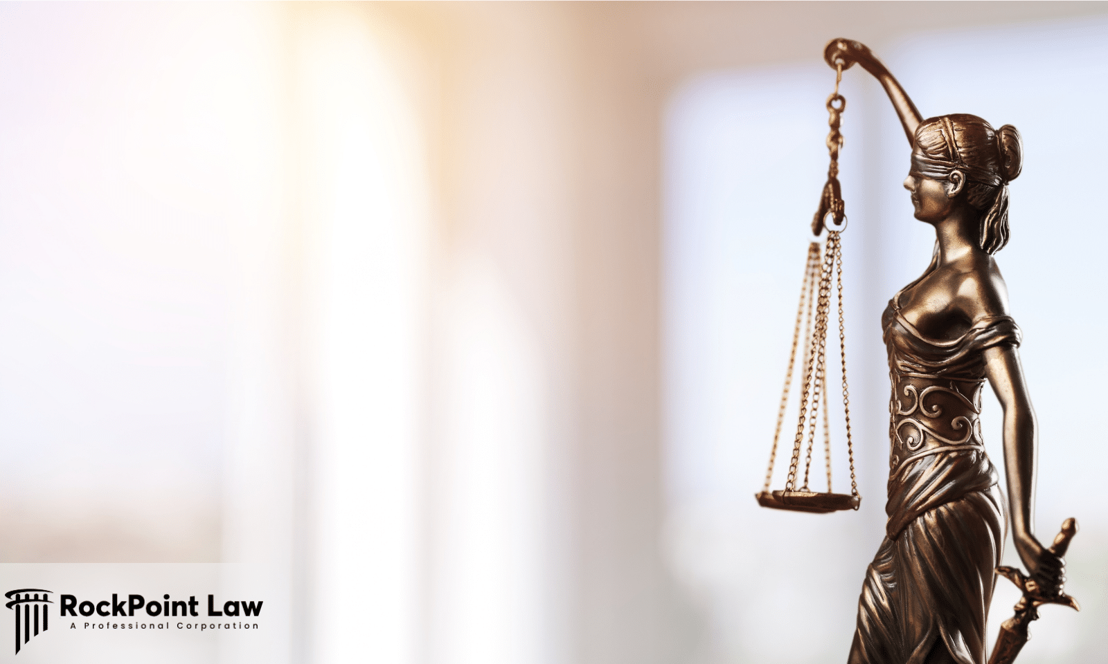 Lady Justice statue holding scales and a sword, representing Lemon Law consumer protection.