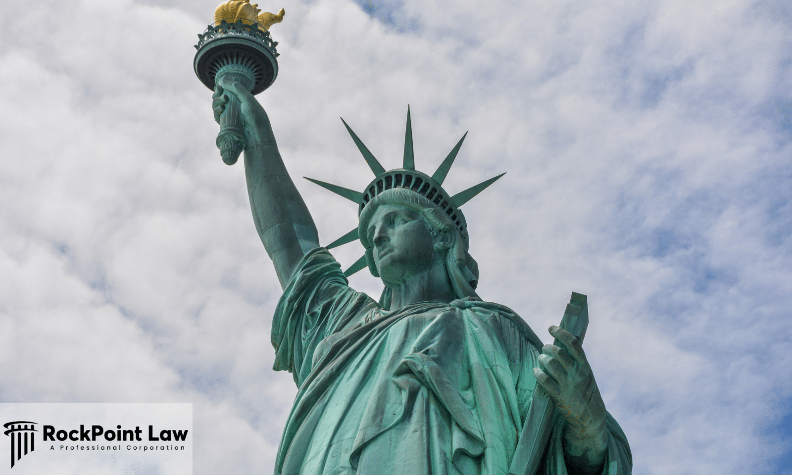 The Statue of Liberty against a cloudy sky, representing consumer protection rights in New York.