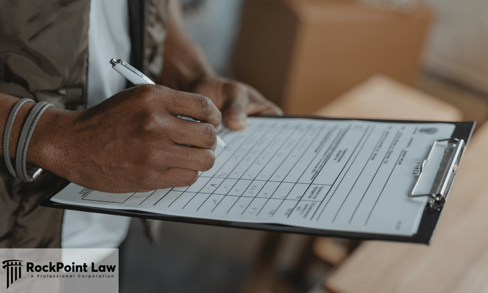 Person filling out a form on a clipboard, representing the repair orders and records needed for a Pennsylvania lemon law claim