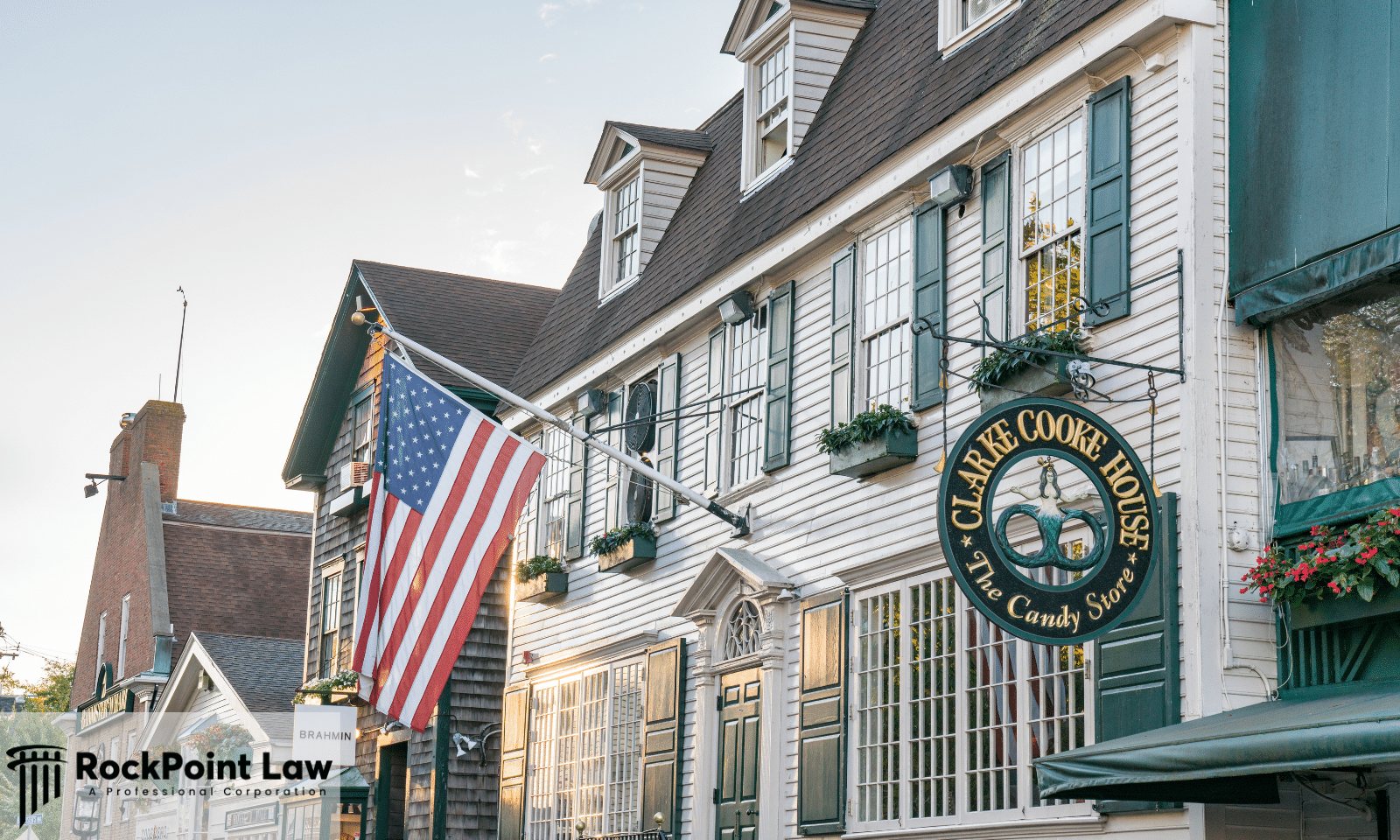 Historic Newport street with an American flag outside a colonial building, representing Rhode Island lemon law examples