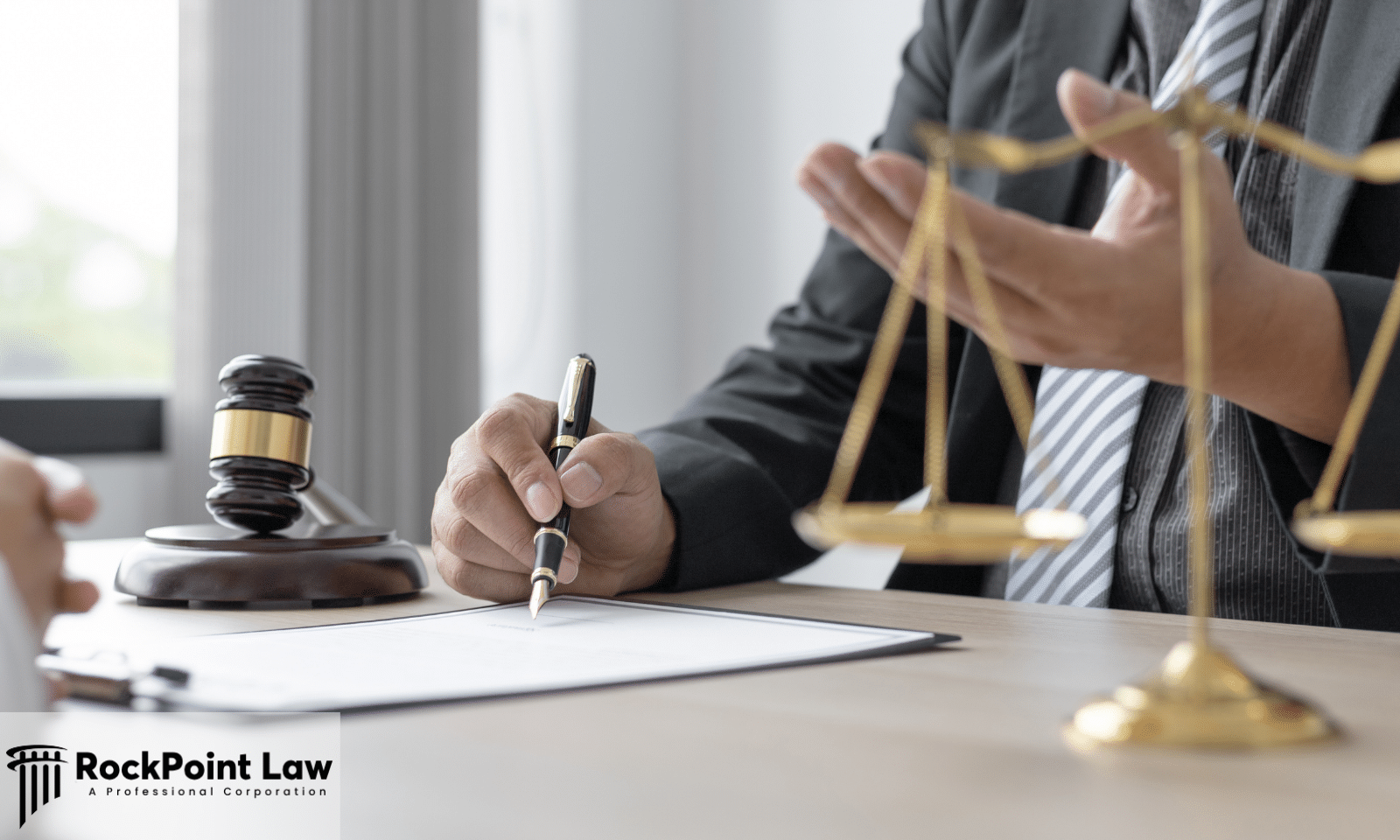 Attorney signing a document beside a gavel and the scales of justice, representing a South Carolina lemon law claim
