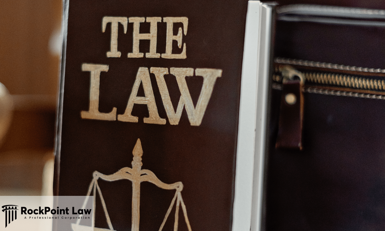 Law book titled The Law beside a briefcase, representing Utah lemon law examples