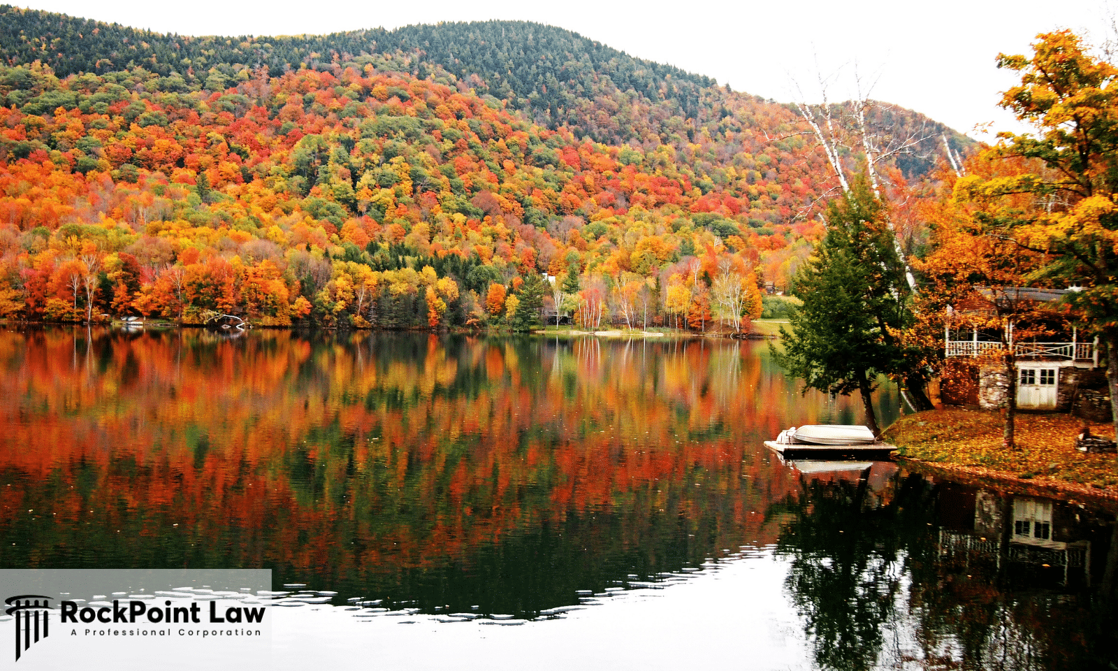 Fall foliage along a Vermont lake, where state lemon law protects new vehicle owners