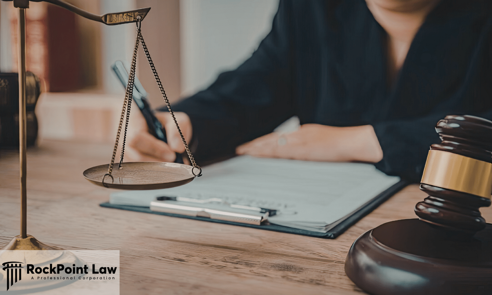 Attorney reviewing legal documents with scales of justice and gavel while handling a Lemon Law claim.