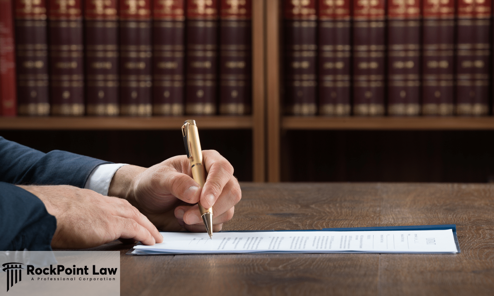 Attorney signing a document at a desk in a law library, representing the paperwork that supports a Wisconsin Lemon Law claim.